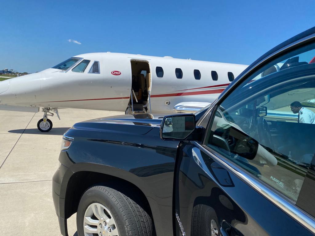 Black Car standing beside Private jet for Airport Pickup